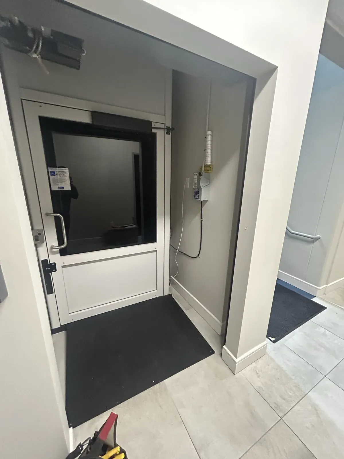 Vertical platform lift enclosure with accessibility signage
