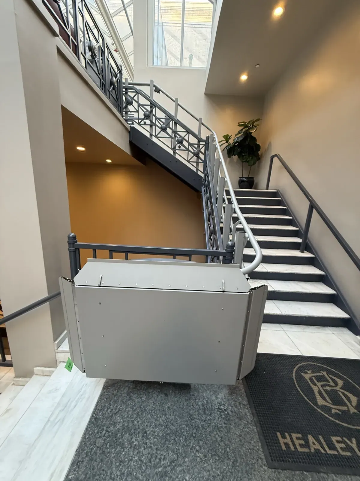 Inclined platform lift on the staircase at the Healey Building