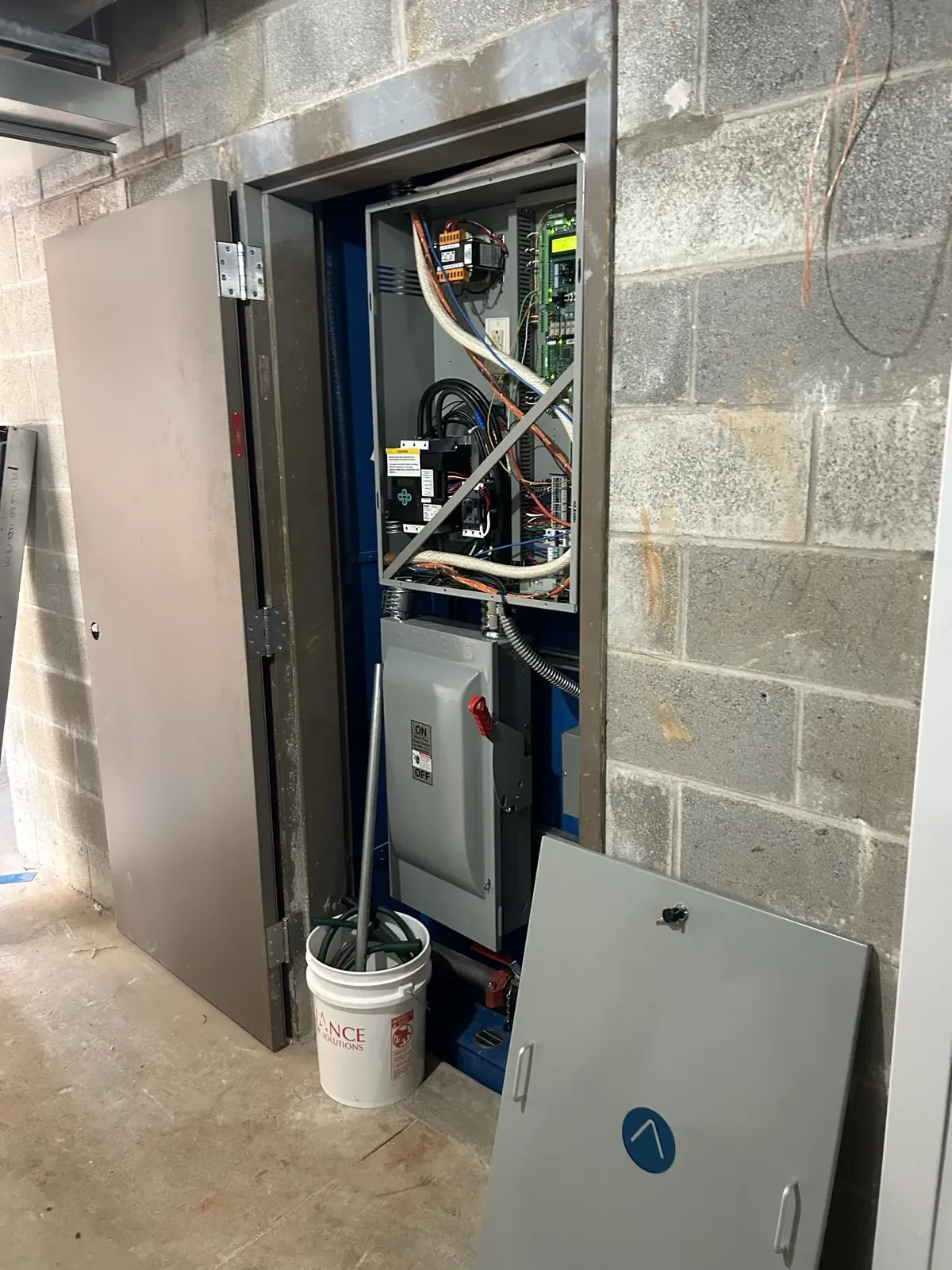 Elevator controller and disconnect in a machine space